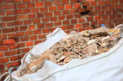 Worker using tools to clear a garden bed in a Paddington residential area
